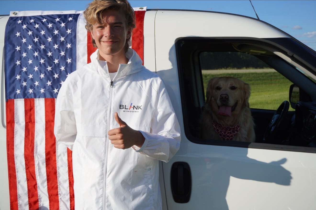 Blank Windows owner Scott Schulz in branded gear beside the company van
